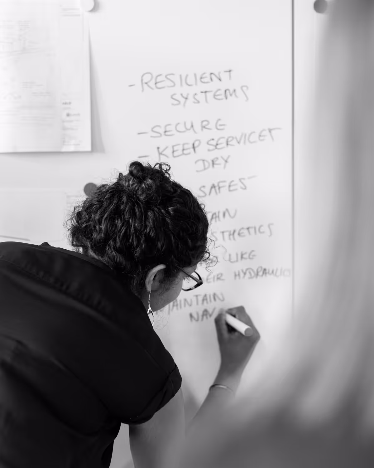 Person writing on whiteboard